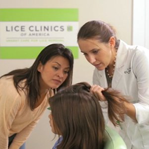 A trained lice-removal technician determining extent of lice infestation